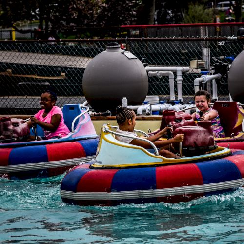 People are enjoying a ride on bumper boats in a water park attraction.