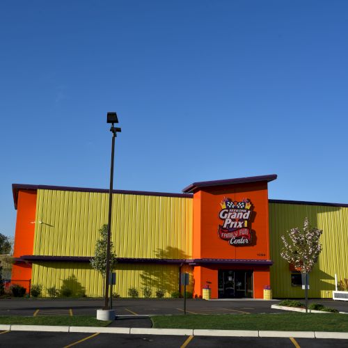 A brightly-colored building with a sign that reads 